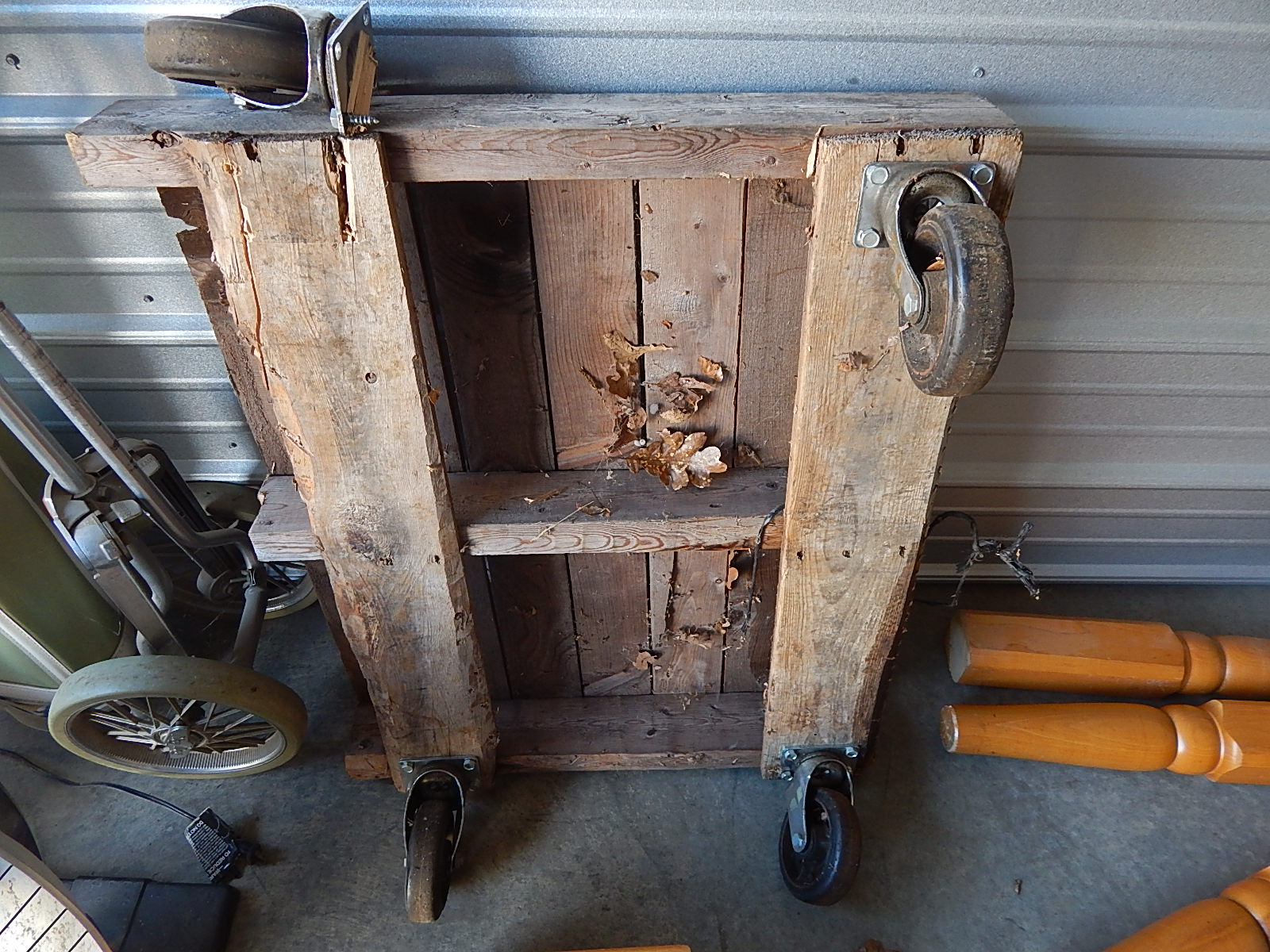14-Wooden Pallet w/ Large Caster Wheels (one needs reattached)